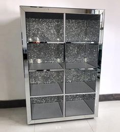 an empty display case with glittered glass doors