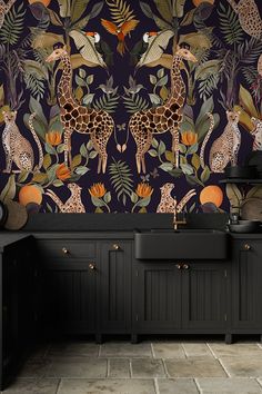 the wallpaper in this kitchen is colorful and has giraffes on it