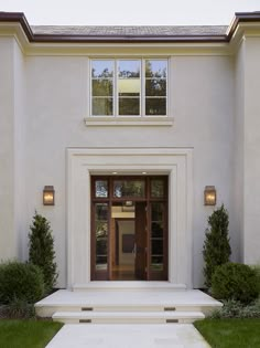 the front entrance to a home with steps leading up to it's entry door