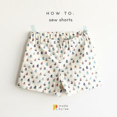 a pair of white shorts with blue, red and green birds on them that say how to sew shorts