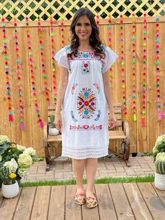 This Beautiful Floral embroidered Dress is the perfect dress to add to your wardrobe. Its cute enough to dress up for a party or everyday wear! It's lightweight, handmade out of Fine Mexican cotton, has beautiful details crocheted throughout and is lined in lace. This dress is handmade and hand embroidered by Mexican Artisans in Puebla, Mexico. Purchase the shoes modeled here: https://www.etsy.com/es/listing/827076671/huarache-megan-artesanal-mexicano-zapato?ref=listings_manager_grid Multicolor Floral Embroidered Knee-length Dress, Multicolor Floral Embroidery Knee-length Dress, Knee-length Multicolor Floral Embroidery Dress, White Summer Dress With Embroidered Sleeves, White Geometric Embroidered Short Sleeve Dress, White Short Sleeve Embroidered Dress With Geometric Pattern, White Short Sleeve Dresses With Intricate Embroidery, White Short Sleeve Dress With Geometric Embroidery, White Embroidered Dress With Short Sleeves