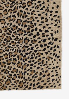 an animal print rug with black and brown spots on the front, beige background to the back