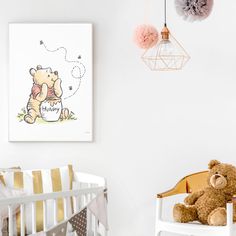 a teddy bear sitting in a crib next to a baby's nursery wall