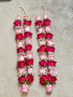 two pairs of pink and red roses with pearls