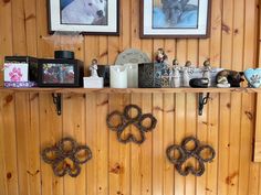 there are many items on the shelf in this room that is decorated with wood paneling