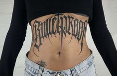 a woman with a tattoo on her stomach