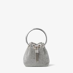 Our signature Bon Bon handbag is crafted in silver crystal mesh. A statement accessory to love forever, it is finished with a sparkling crystal top handle and a sleek drawstring chain that cinches the supple shape. Designed with chain strap for versatile styling. Monogrammed Cuff, Crystal Top, Bridal Bag, Luxury Belts, Evening Handbag, Bon Bon, Silver Crystal, Mesh Bag, Sparkling Crystal