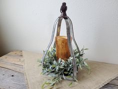 a wooden block with greenery in it sitting on top of a burlock