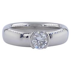 Tiffany & Co. Etoile Diamond Solitaire Engagement Ring Style: ETOILE Ref. number: 27676642 Metal: PT950 Platinum Size: 5.75 sizable TCW: 0.56 cts Main Diamond: Round Brilliant Diamond Color & Clarity: H, VVS2 Hallmark: ©TIFFANY&Co. PT950 27676643 .56CT Includes: T&C Ring Box - Certified Appraisal Retail: $6,850 Sku#16000TLK070621-5.75 Tiffany Engagement Ring Erstwhile Jewelry, Luxury Engagement Rings Tiffany & Co., Tiffany Co Rings, Engagement Rings Platinum, Tiffany And Co, Diamond Solitaire Engagement Ring, Engagement Ring Styles, American Diamond, Jewelry Rings Engagement