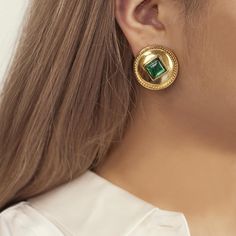 model wearing circular gold clip on earrings Formal Earrings For May Birthstone, Elegant Green Gold-plated Earrings, Gold Jeweled Earrings For Formal Occasions, Elegant Green Gemstone Clip-on Earrings, Formal Gold Earrings With Jewels, Luxury Jeweled Earrings For Gift, Luxury Green Clip-on Earrings As Gift, Formal Green Earrings With Metal Plating, Green Plated Earrings For Formal Occasions