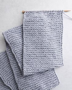 three crocheted dishcloths sitting next to each other on top of a table