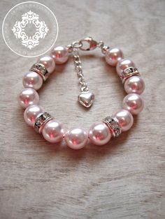 Swarovski Pink Pearl bracelet The perfect little gift for a baptism, blessing, Christening, baby shower, Flower girl, Communion, birthday, or just because! The SWAROVSKI Pearl baptism bracelet is handmade and custom designed for your special baby girl.The bracelet is made with high Pink Pearl Bracelet For Birthday, Pink Pearl Beaded Bracelet For Birthday, Pink Beaded Jewelry For Baptism, Pink Pearl Bracelets For Mother's Day, Pink 8mm Beads Jewelry For Wedding, Pink Pearl Jewelry With 8mm Beads, Elegant Pink Pearl Bracelet With 8mm Beads, Elegant Pink Pearl Bracelet For Birthday, Elegant Beaded Jewelry For Baptism