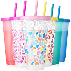 four different colored cups with straws in them