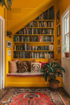 a living room with yellow walls and lots of books on the book shelf above the couch