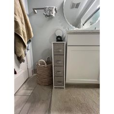 a bathroom with a sink, mirror and towel rack