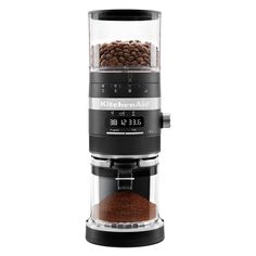 a coffee grinder filled with beans on top of a white background