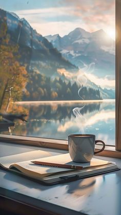 a coffee cup sitting on top of a table next to a window