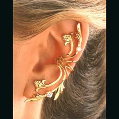 The Fleur di Lei Ear Cuff. This is a full ear Ear Cuff with leaves, flowers & CZ (cubic zirconia) ear cuff that climbs down as well as up the side of the ear. Delicate, yet very exotic looking. This is very popular with Brides. PRICED AS A SINGLE LEFT or RIGHT, OR a save on a PAIR ($289.00 / PAIR) Handmade in Solid Sterling Silver (UN-plated), Yellow Gold Over Sterling Silver or White Rhodium over Sterling for Easy Care. This ear cuff can be made for the left or the right side, and a pair ca Wedding Sterling Silver Ear Cuff, Yellow Gold Sterling Silver Wedding Ear Cuff, Wedding Yellow Gold Sterling Silver Ear Cuff, Fine Jewelry Gold Ear Cuff For Weddings, Gold Fine Jewelry Ear Cuff For Wedding, Gold Clip-on Ear Cuff For Wedding, Gold Fine Jewelry Ear Climbers For Wedding, Elegant Pierced Ear Cuff For Anniversary, Gold Sterling Silver Ear Climbers For Wedding