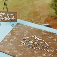 two wooden signs with names on them sitting on a table