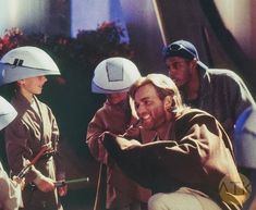 a group of people with helmets on and one holding a toothbrush in his mouth