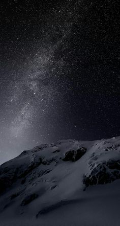 the night sky is filled with stars above a snow covered mountain side and there are no clouds in sight