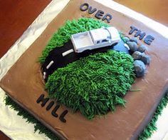 a cake decorated with green grass and a car