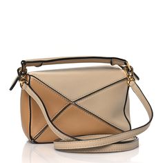 This is an authentic LOEWE Calfskin Mini Puzzle Bag in Dusty Beige and Soft White. This chic handbag is finely crafted of soft, supple calfskin leather in shades of beige and white. The bag features a rear zipper pocket, a rolled top handle, and an adjustable leather shoulder crossbody strap with polished gold hardware. The top zipper opens to a beige fabric interior with a pocket. Mini Puzzle, Puzzle Bag, Shades Of Beige, Beige Fabric, Chic Handbags, Soft White, Crossbody Strap, Gold Hardware, Top Handle