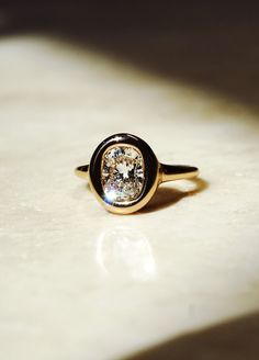 a diamond ring sitting on top of a table