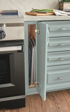 an open cabinet in the middle of a kitchen