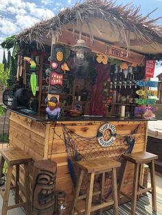 an outdoor bar with stools and decorations