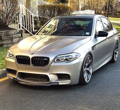 a silver car is parked on the street