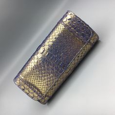 Fatto A Mano By Carlos Falchi Metallic Gold & Purple Python Clutch Stunning! Rare! Approx. Size: Strap Drop: 3" Height: 3" Width: 6.75" Depth: 1" Magnetic Closure. Single Gold Tone Drop-In Chain-Link Shoulder Strap (Can Be Hidden Inside). Multi-Color Lining. Original Dust Bag. Nwot. New Without Tags. Never Worn. Smoke-Free Storage. 5 Star Seller. Fast Shipping. Authenticity Guaranteed. Purple Gold, Metallic Gold, Magnetic Closure, Python, Chain Link, 5 Star, Gold Metal, Dust Bag, Gold Tones