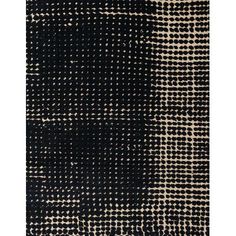 a black and white rug with small squares on the bottom, in different sizes and colors