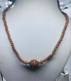 Welcome, Namaste  100% AUTHENTIC  RUDRAKSHA NECKLACE RUDRAKSHA MUKHI FACE - 5 FACE LENGTH OF NECKLACE CHAIN  - 40 CM CHOKER NECKLACE FEATURES - 12 mm panch mukhi Rudraksha IN MIDDLE OF 108 SMALL RUDRAKSHA 4 mm BEADS with lobster hooks at end to open and close We offer 100% Money Back, No Questions Asked. Bid with confidence. The beads of this mala are 100% original and genuine. Holistic Necklaces With 8mm Beads For Rituals, Holistic Necklaces With 8mm Beads For Festivals, Spiritual Round Beads Jewelry For Puja, Hand-strung Spiritual Necklaces For Puja, Spiritual Gemstone Beads Necklaces For Festivals, Hand-strung Spiritual Necklace For Puja, Spiritual Hand-strung Necklaces For Puja, Handmade Brown Necklace For Puja, Spiritual Single Strand Round Necklace