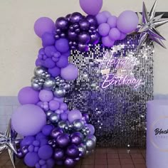 purple and silver balloon arch with star decorations