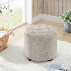 a round ottoman sitting on top of a white rug