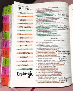 an open bible with colorful writing on it