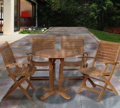 three wooden chairs and a table on a patio