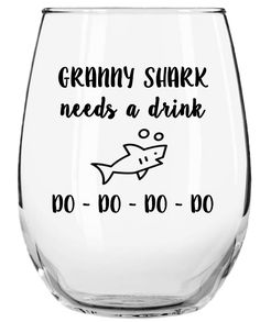 a wine glass that says, granny shark needs a drink do - do - do