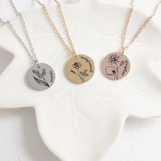 Personalized coin birth flower with name necklace, this pendant makes a great birthday gift for daughter, mom and grandma and also for your best friends. You can customize the front of the pendant with the birth flower  of your choice and a name. The disc necklace is made of stainless steel and it measures 0.8" / 18 mm available in four colors: gold, rose gold, black and silver. The pendant comes with and adjustable stainless steel (18-20") chain that will fit just perfect on any body type. This Engraved Flower Pendant Charm Necklace For Mom, Engraved Flower Pendant Necklace For Mom, Round Flower Charm Necklace As Gift For Mom, Mother's Day Round Charm Necklace With Flower, Mother's Day Round Flower Charm Necklaces, Mother's Day Round Flower Charm Necklace, Mother's Day Jewelry With Birth Flower Medallion, Mother's Day Medallion Jewelry With Birth Flower, Personalized Birth Flower Medallion Necklace