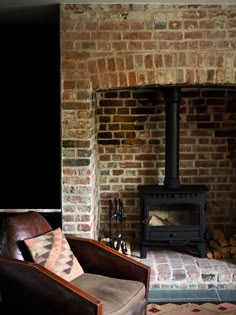 a living room with a fire place next to a chair