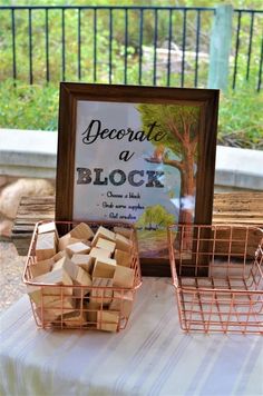 a table topped with baskets filled with blocks of wood next to a sign that reads, record a block