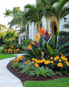 tropical landscaping with flowers and palm trees in the background