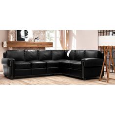 a black leather sectional sofa in a living room