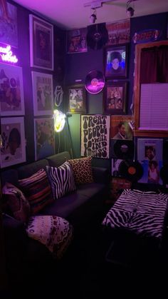 a living room with purple lighting and zebra print pillows on the couch in front of it