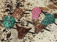 Tooled leather hair  stick barrettes that are the perfect touch of cowgirl flair. Classic designs that go with just about any outfit and are tooled in traditional florals and southwest designs. Each one is hand made and one of a kind. Leather Hair Pin, Tooled Leather Hair Accessories, Stick Barrettes, Tooled Leather Badge Reel, Leather Tooled Keychains, Tooled Leather Bookmark, Tooled Leather Hair Barrette, Old Cowboy Boots, Brush Design