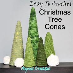 crocheted christmas tree cones with white pom - poms on the bottom