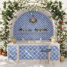 an outdoor bar with blue tile and potted plants on the wall, next to two stools