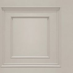 an empty white square frame hanging on the wall