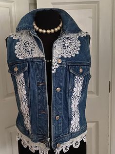 a woman's jean vest with white lace on it